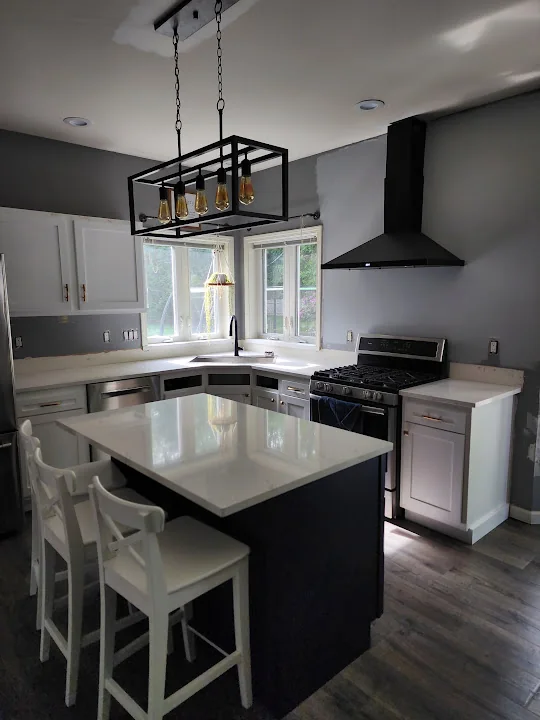 The same white-and-gray kitchen before the hex backsplash was installed