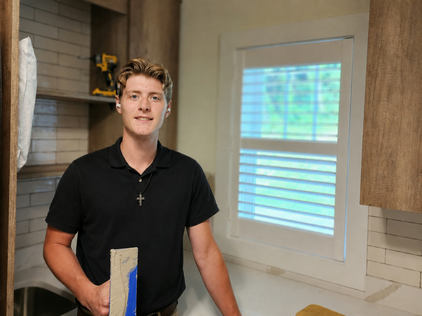 David LaFaver Jr. standing in front of a finished kitchen backsplash