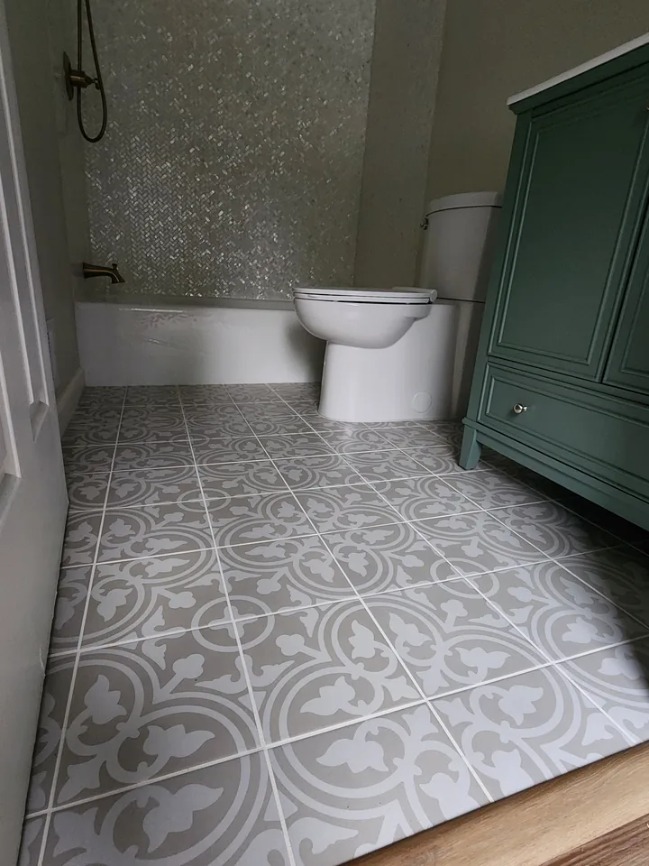 Finished gray and white patterned tile floor in a bathroom