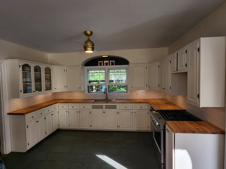Wide view of a finished white subway tile kitchen backsplash