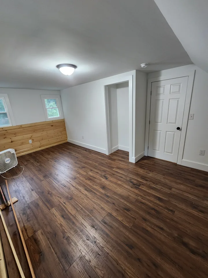 Finished dark wood-look plank flooring in a bright room